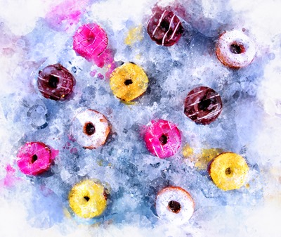 Glazed Doughnuts with colourful sprinkles and icing on dark background